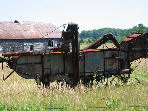 Old farm scene with rusty thrashing machine from an earlier time